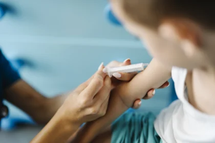 Child receiving vaccination from a healthcare professional.